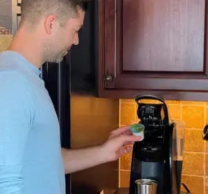 Compostable K-Cup coffee pod placed into a single-serve brewerCompostable K-Cup coffee pod placed into a single-serve brewer